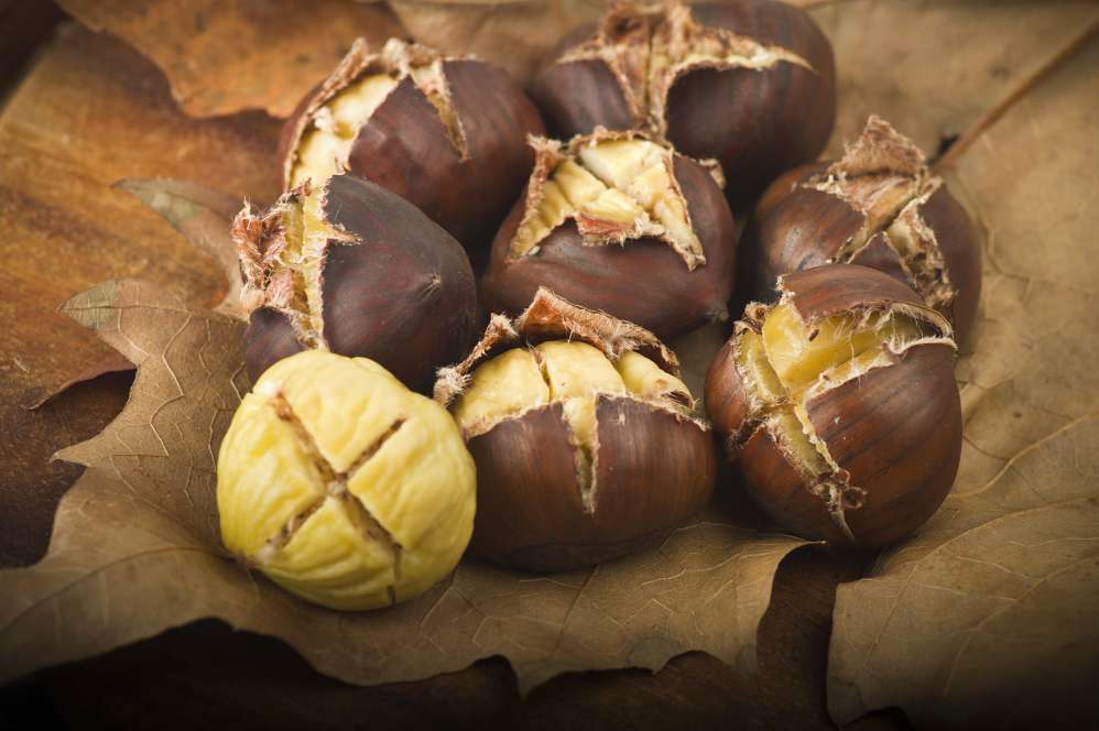group of chestnuts on a wooden table